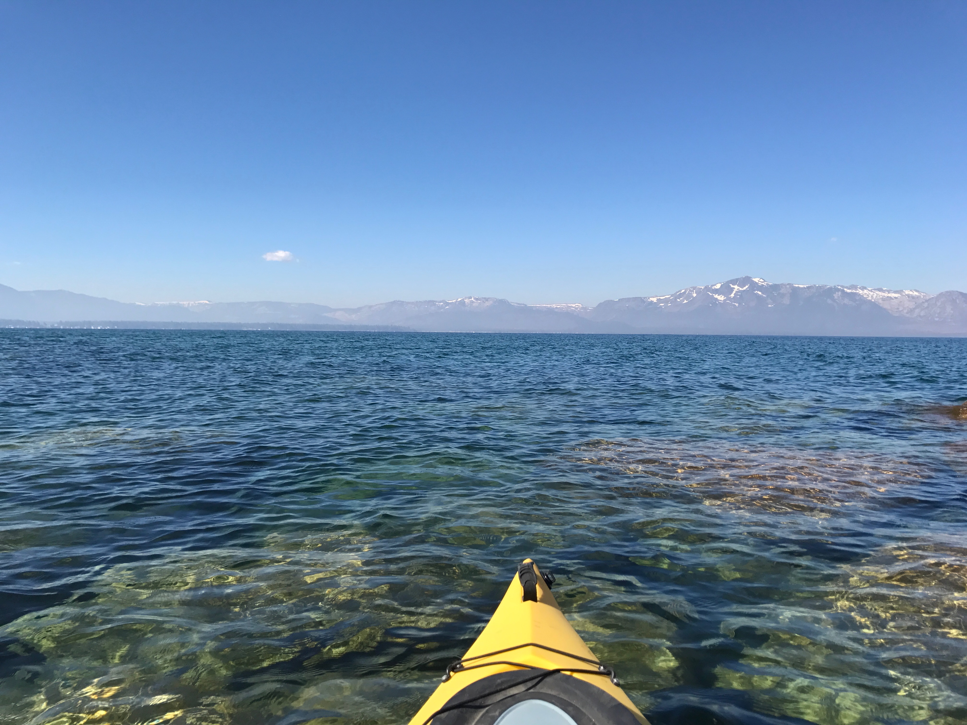 A yellow kayak on the clear waters of Lake Tahoe